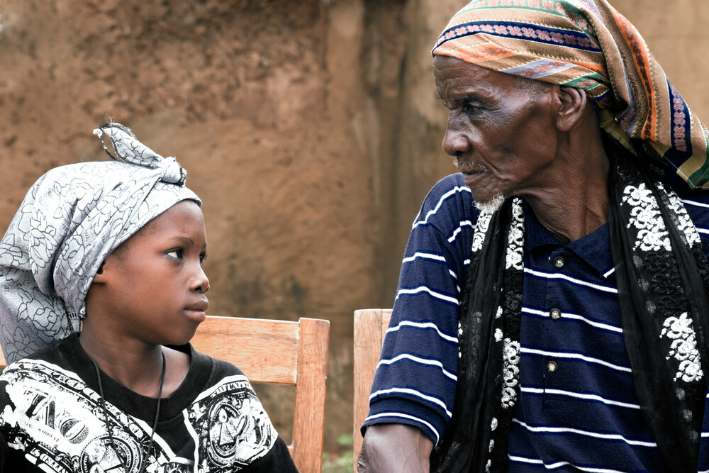 Chief & his grandson of  the village Kumbungu - Fineart photography by Lucía Arias Ballesteros