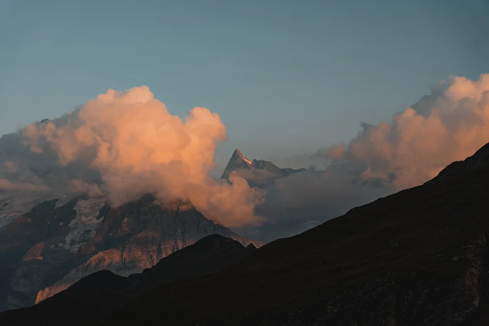 Clouds at golden hour in front of mountains - Fineart photography by Tobias Winkelmann