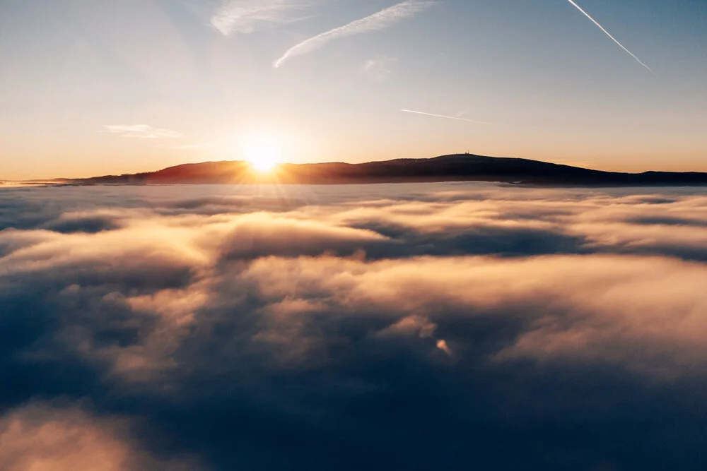 Sunset above the clouds in the Harz Mountains, calm and peaceful atmosphere.