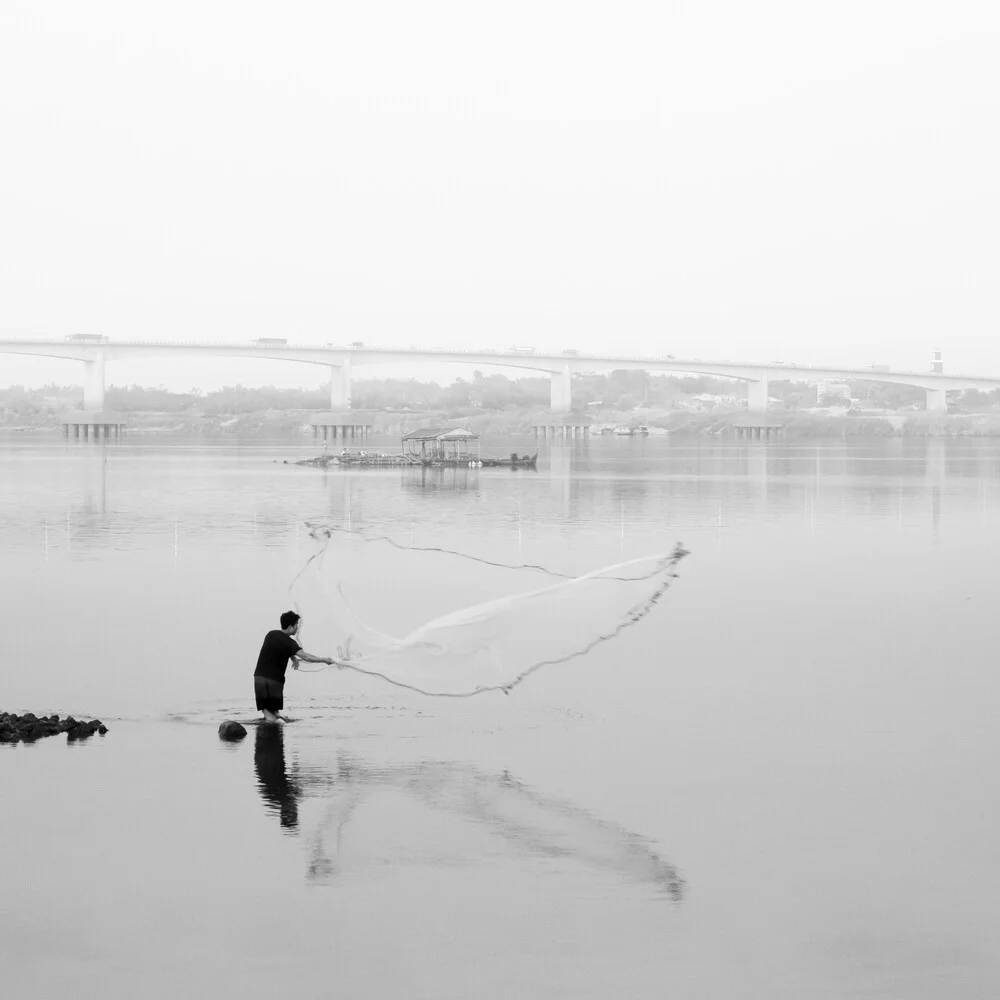 Photo art: Fisher with net on the Mekong, serene mood in soft gray tones