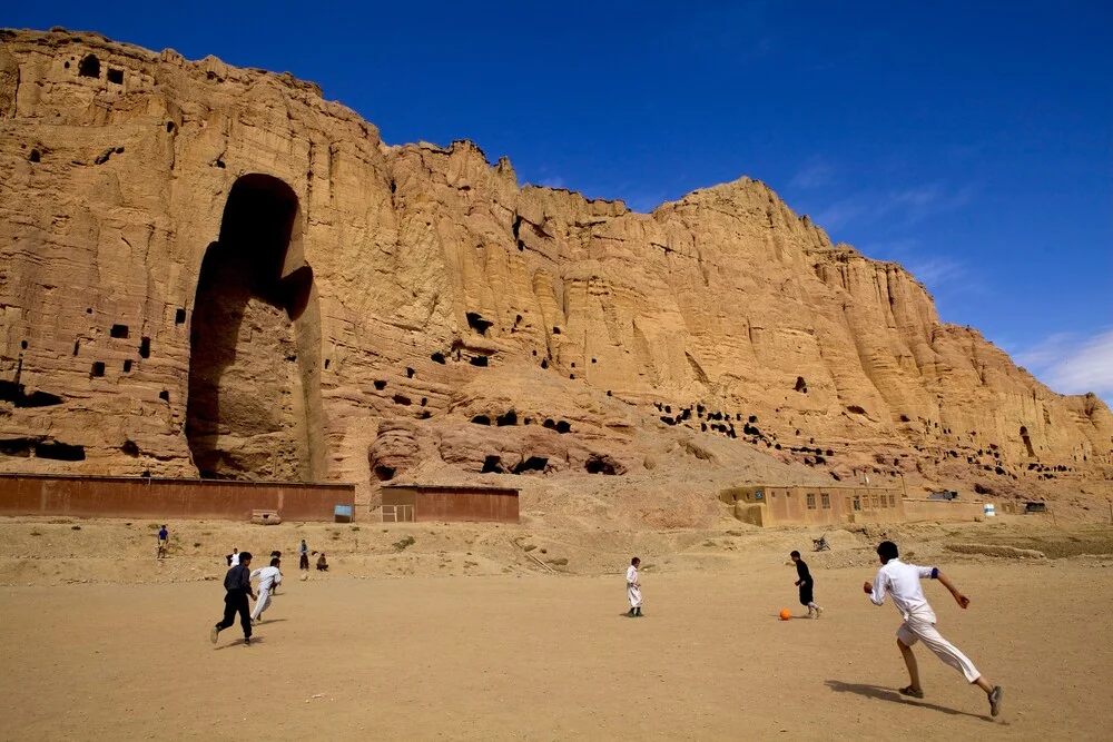 Boys Play football in front of Buddha  - Fineart photography by Rada Akbar