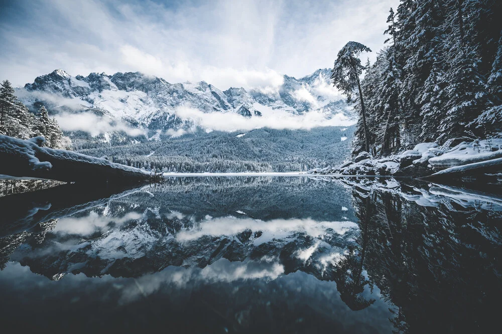 Winter landscape at Lake Eib with snow-covered mountains and calm water surface
