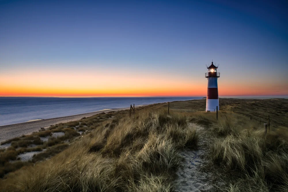 Photo art: Lighthouse on Sylt's coastline at sunrise, calm atmosphere.