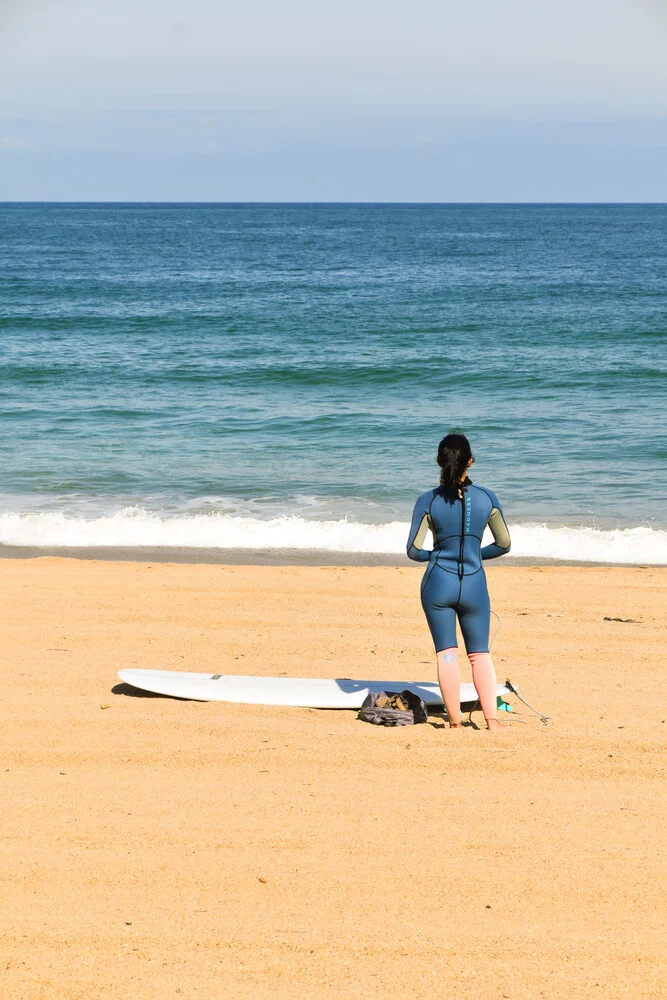 Photo art by Lotte Wildiers: Surfer woman at Biarritz beach during sunset.