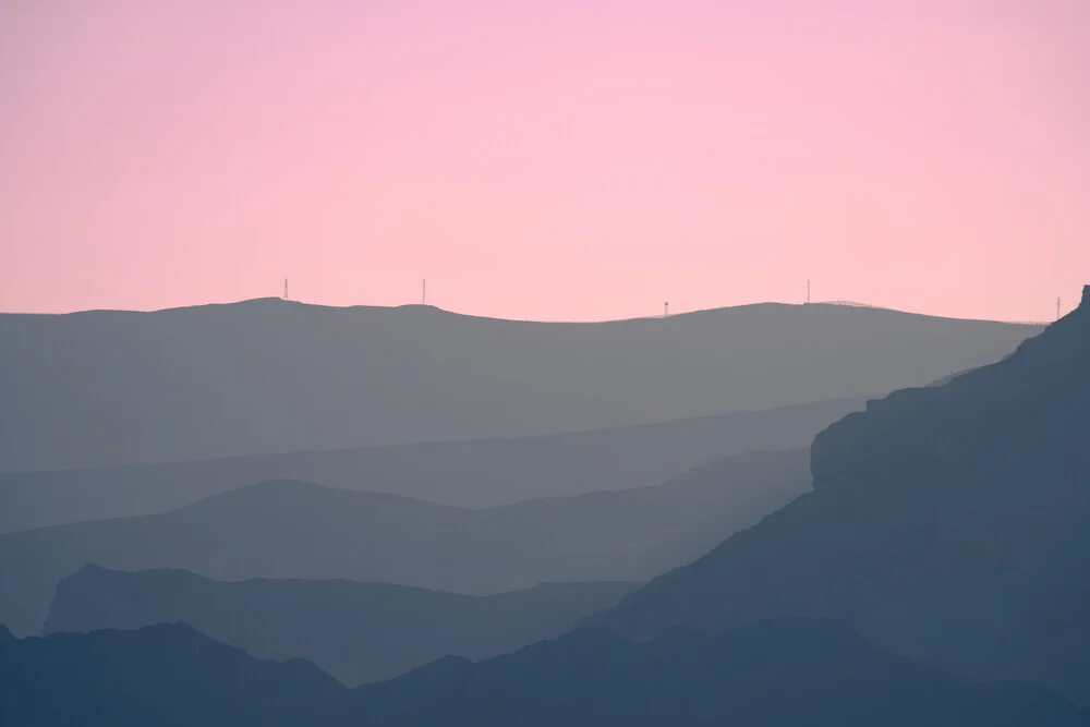 Photo art featuring soft colors and mountain silhouettes at dusk