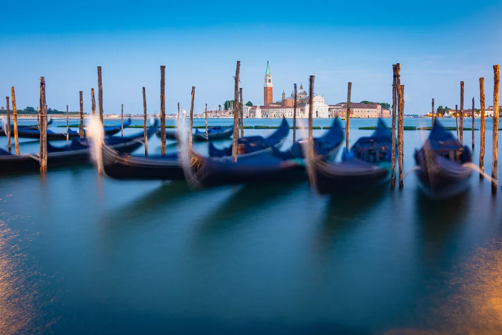 Image by Martin Wasilewski: Venice at dusk with gondolas on the water