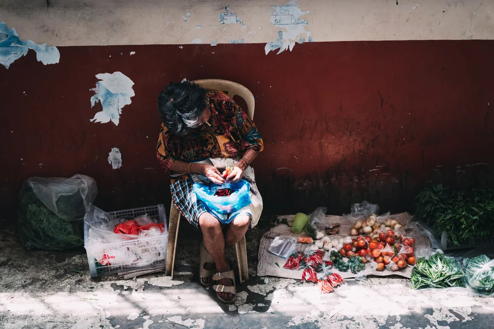 Wall art of an elderly woman selling fresh vegetables at a market in the Philippines