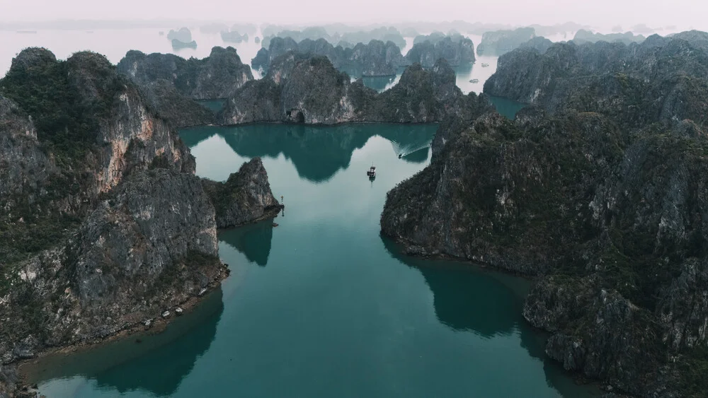 Wandbild von Christian Seidenberg: einsames Boot in der Ha Long Bucht, ruhige Wasseroberfläche.