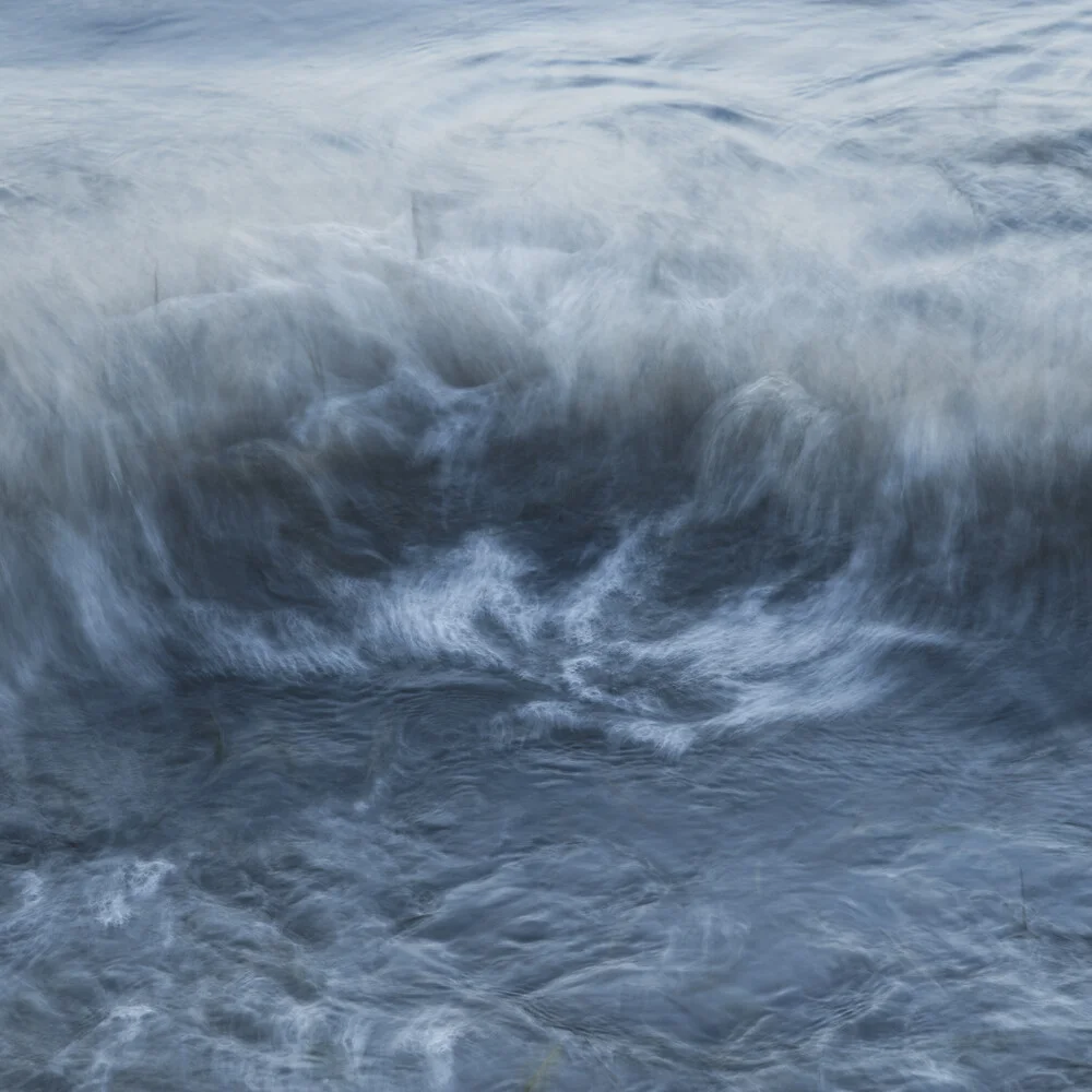 Photo art by Nadja Jacke: flowing sea waves in gentle shades of blue.