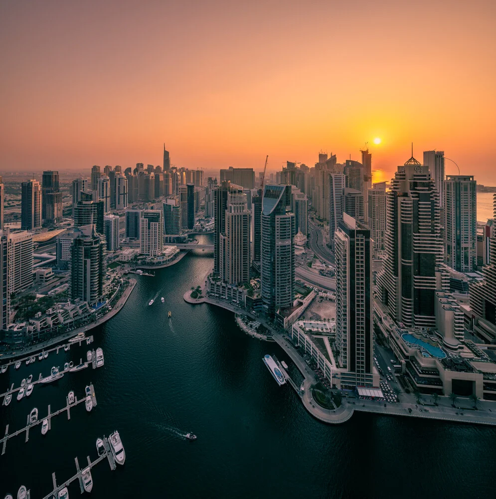 Photo art by Achim Thomae: sunset over Dubai Marina featuring skyscrapers and boats.