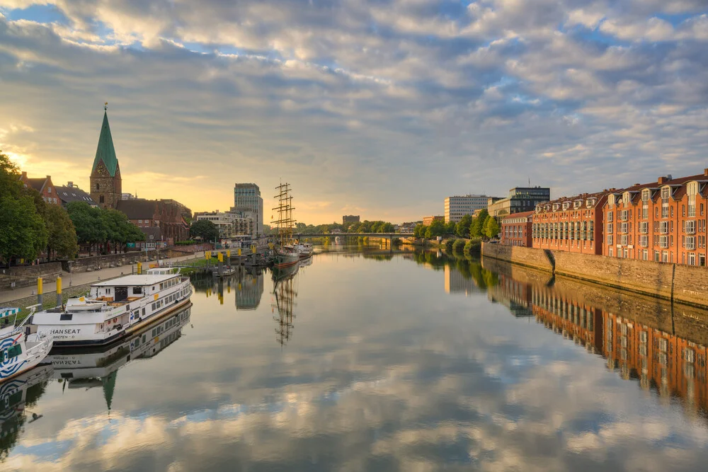View across the Weser in Bremen: gentle morning light reflecting on the city and water.