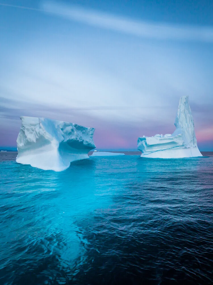 Photo art by Dennis Schmelz: icebergs in deep blue ocean under clear sky