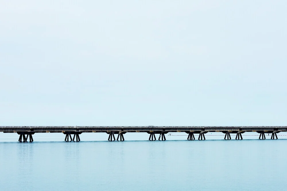Photo art by Manuela Deigert: bridge over calm waters and expansive sky