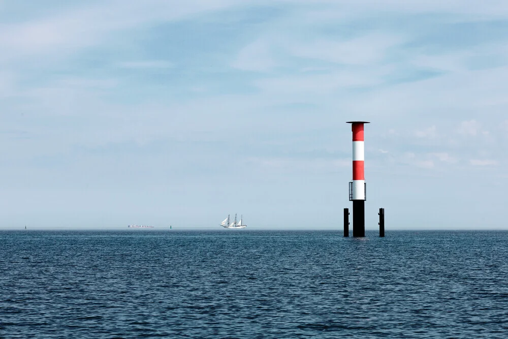 Photo art by Manuela Deigert: calm lighthouse at the North Sea with a sailing boat