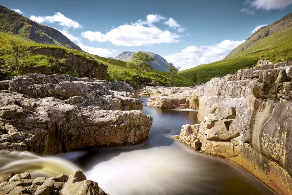 Long exposure of Glen Etive in Scotland, gentle rivers and cloudy sky.