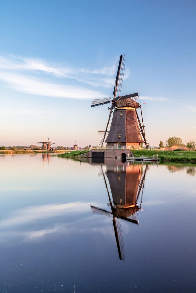 Windmill in Holland: serene landscape with reflection in the water