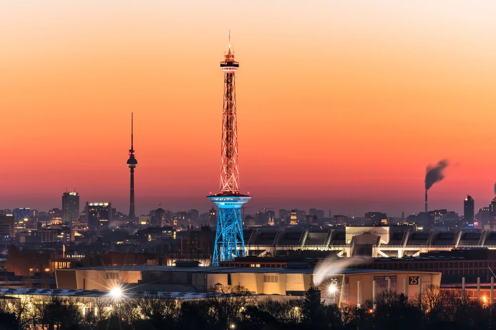 Photo art of a sunrise over Berlin showing the illuminated TV tower and city in morning light