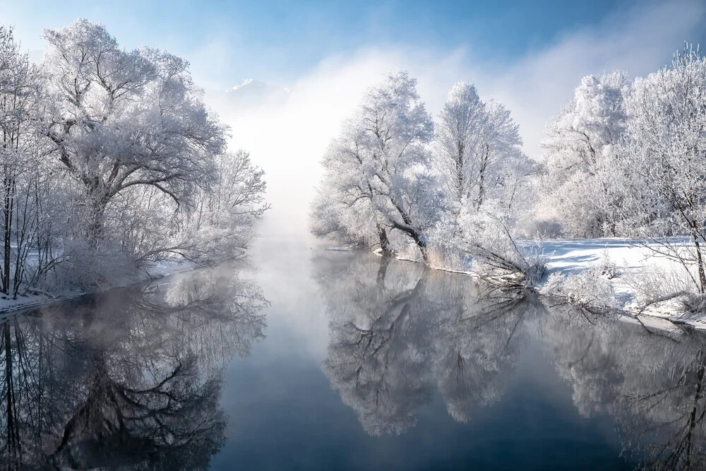 Winter landscape in the Bavarian Alps with gentle fog over Lake Kochelsee.