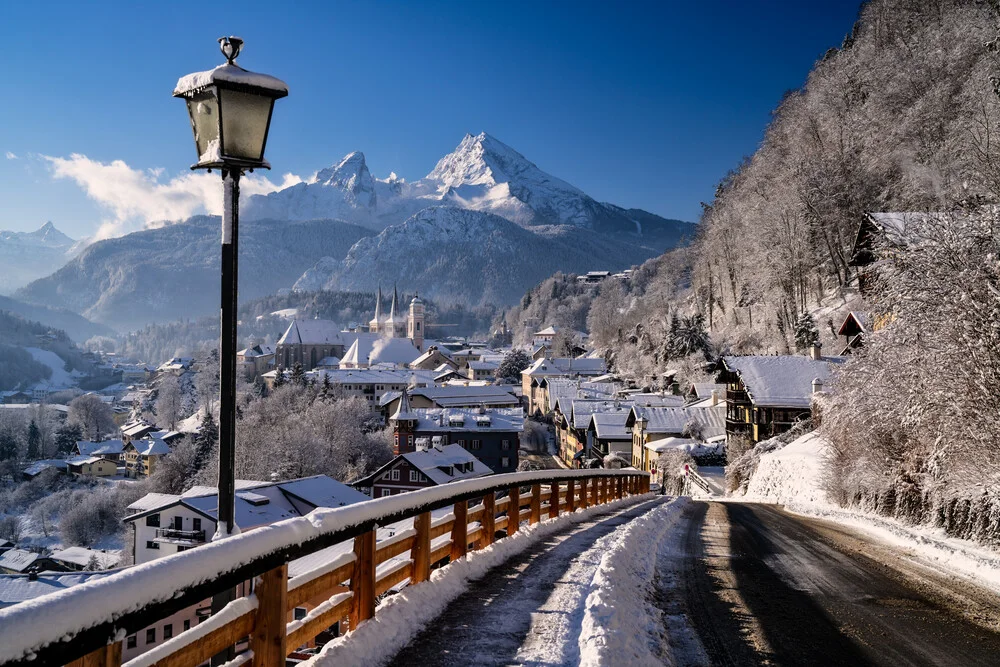 Winter landscape in Bavaria featuring snow-capped mountains and a calm sky