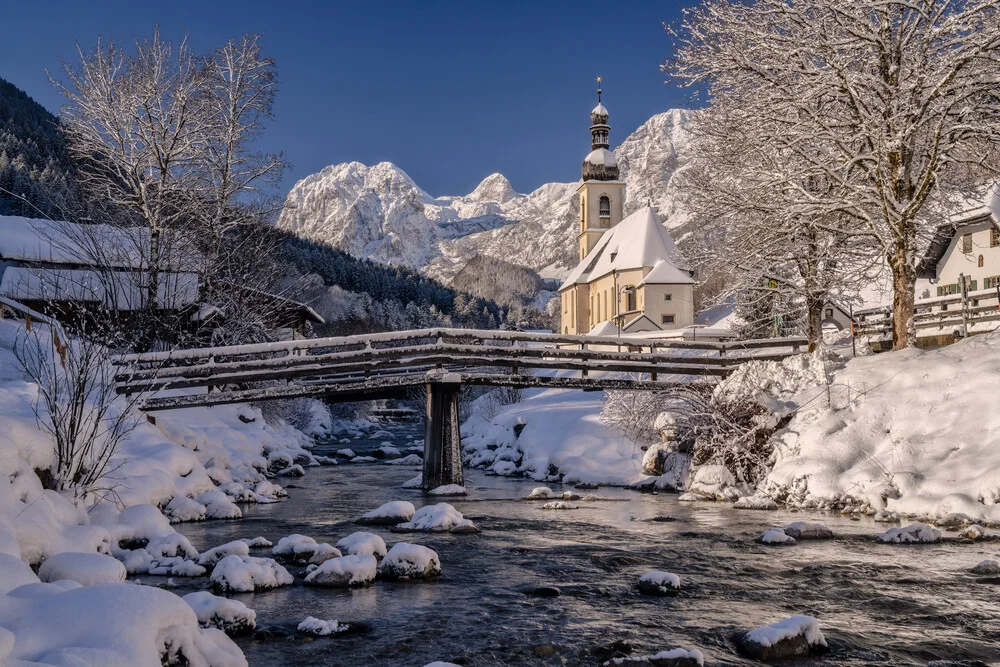 Winter landscape with snow-covered mountains and a church in Upper Bavaria