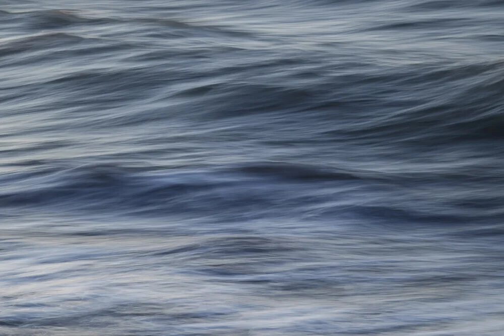 Photo art: gentle wave movement at the coast, calming shades of blue