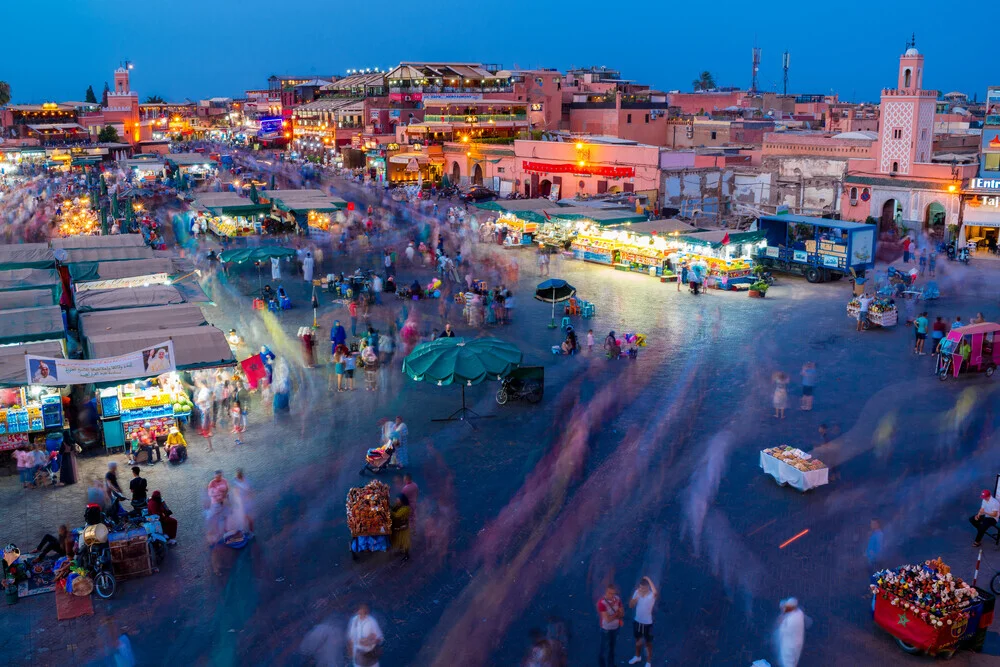 Market in Marrakech, vibrant scene with colorful stalls and cheerful people.