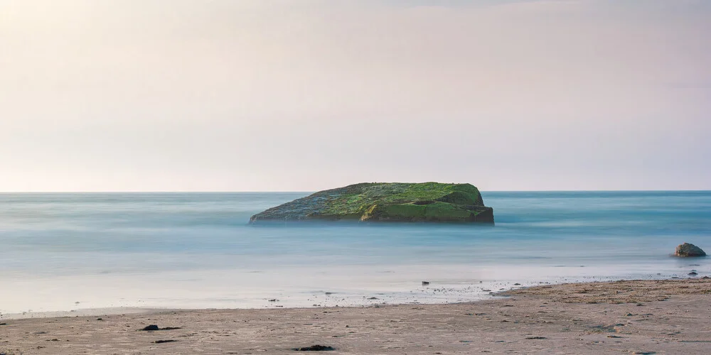 Serene bunker in soft greens at the beach during the blue hour.