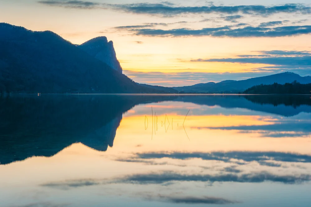 Photo art by Martin Wasilewski: Dragon Wall reflected in the calm Mondsee at sunset.