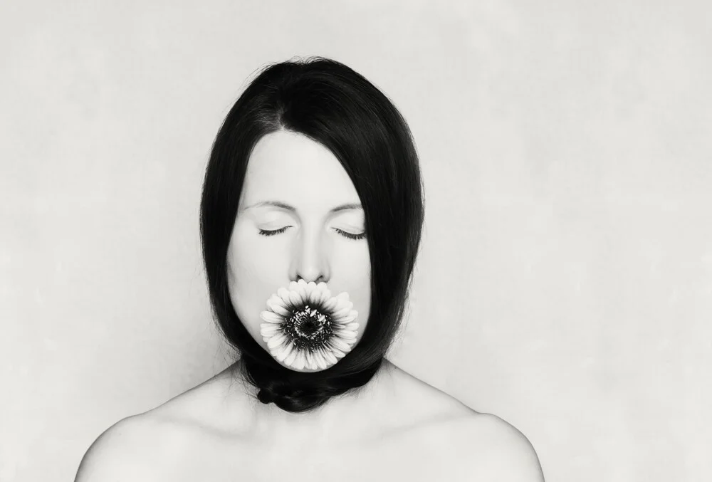 Photo art by Manuela Deigert: Woman with blooming Gerbera flowers in soft tones.