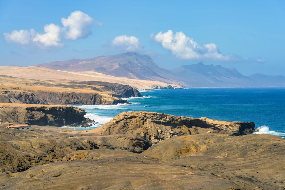 Photo art captures the coast near La Pared on Fuerteventura with gentle waves and clear skies.
