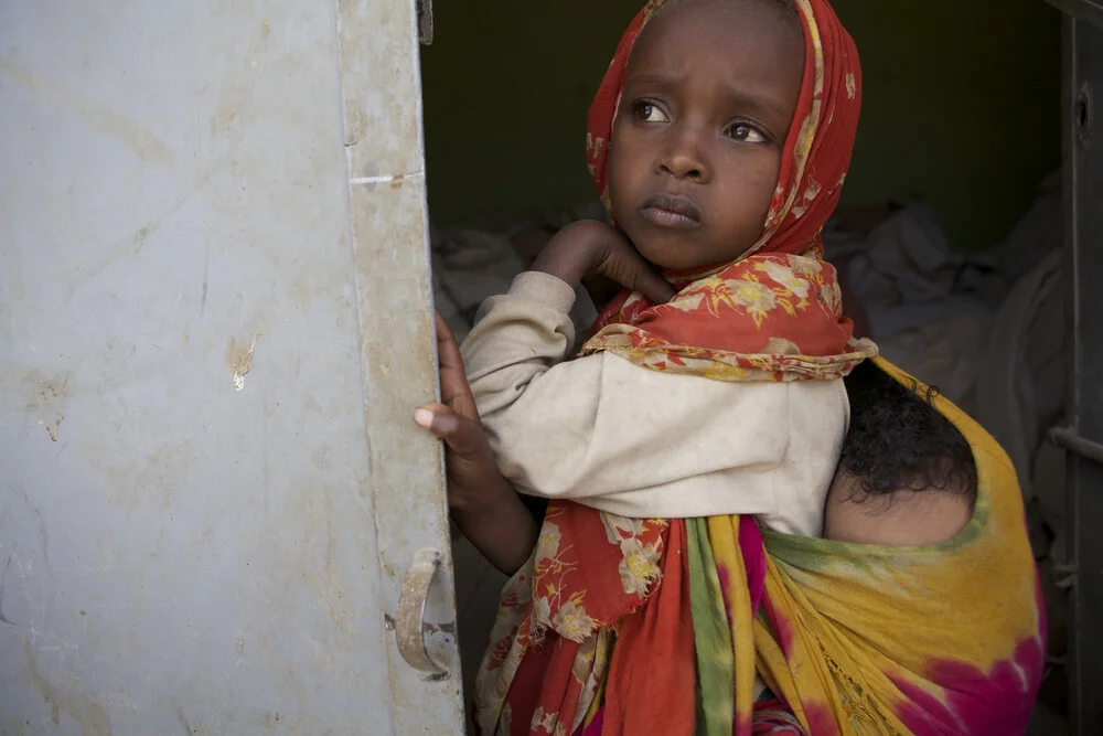 Young girl with her baby brother, Ethiopia - Fineart photography by Christina Feldt