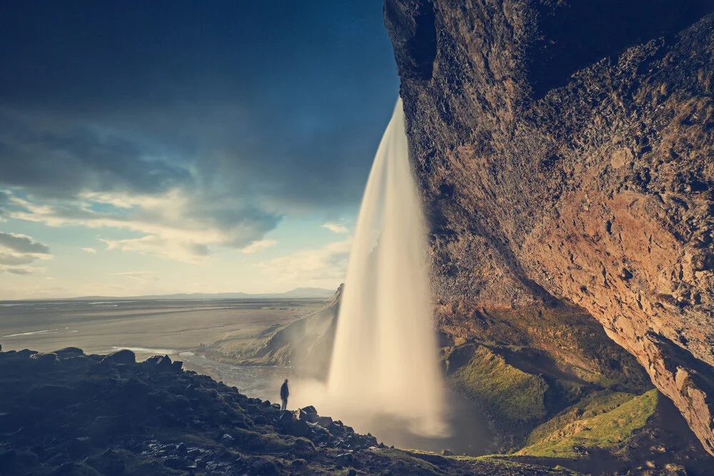 Seljalandsfoss at golden hour with one person - Fineart photography by Franz Sussbauer