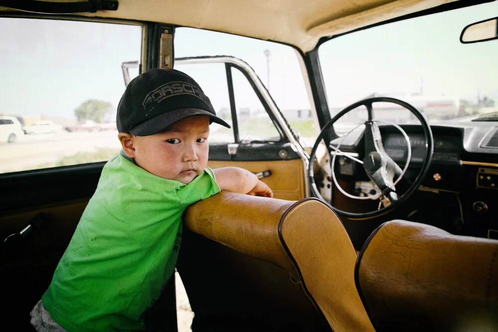 Boy in old Lada in Kyrgyzstan - Fineart photography by Victoria Knobloch