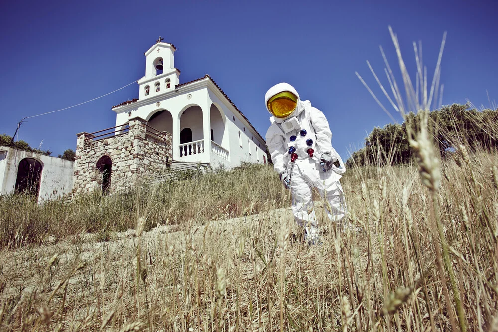 The Protestonaut in front of a a chapel in Greece. - Fineart photography by Sophia Hauk