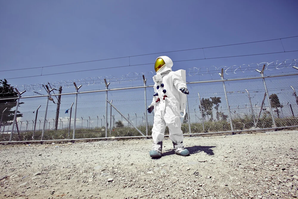 The Protestonaut in front of the border fence in Idomeni - Fineart photography by Sophia Hauk