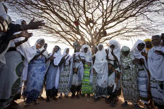 Photo art by Walter Luttenberger: joyful dance scene in Kenya with women and children