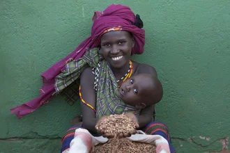 Photo art by Walter Luttenberger: mother with baby and grain in Kenya.