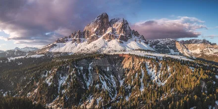 Aerial view of Peitlerkofel at sunrise with soft clouds and mountains