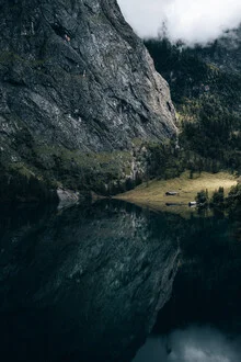 Moody photo art: tranquil mountain lake reflecting the sky.