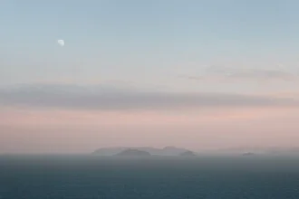 Photo art by AJ Schokora: serene view of the moonrise over the ocean