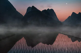 Photo art featuring gentle reflections in rice paddies beneath a misty sky