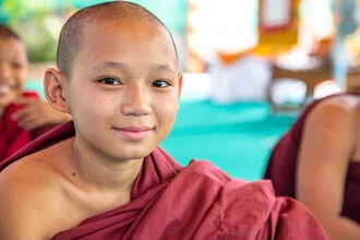 Photo art of a monk in Myanmar walking to a monastery, conveying a peaceful mood.