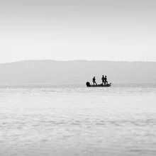 Fisherman on a boat in a calm lake, soft colors and a relaxed atmosphere.