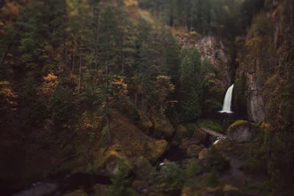 Photo art by Kevin Russ: waterfall in nature with trees and mountains in the background