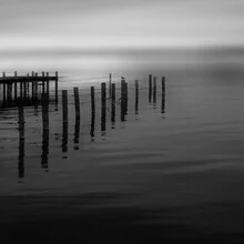 Black and white photo of a bridge over a misty lake