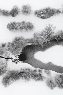 Photo art depicts a snowy winter landscape with a calm lake and snow-covered trees.