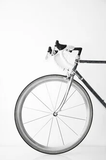 Black and white photo of a bike in a calm urban setting.
