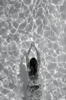 Black and white photo art: a woman in water, minimalist composition with gentle lines.