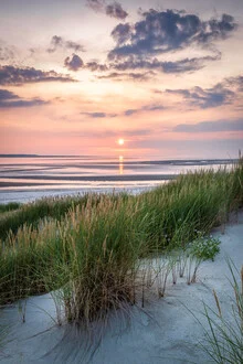 Sunset at the dune beach with gentle waves and warm colors