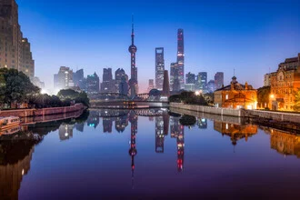 Photo art by Jan Becke: night skyline of Pudong in Shanghai with building reflections.